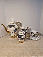 Front view of full porcelain tea set showing all five pieces