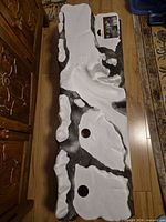 Top view of full snow-rock plastic base showing overall shape and two mounting holes
