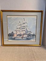 Full view of framed print showing image, mat and gold frame