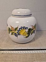 Frontal view of jar with ruler showing height ~5.5 in