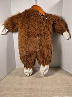 Back view of full brown faux fur toddler costume on hanger