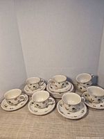 Group shot of all teacups and saucers showing quantity and design