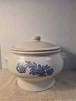 Front view of white stoneware soup tureen with blue floral print and lid