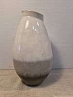 Front view of white and beige glazed ceramic vase