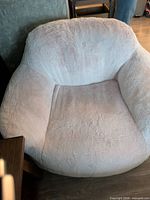 Front view of light pink faux-fur oversized chair