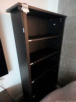 Front view of black bookcase showing shelves and overall height