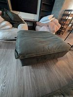 angled top and side view showing dark green microfiber upholstery and attached cushion