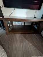 Full view showing coffee table with lower shelf and X-brace legs