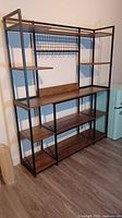 Full view of assembled metal frame bookshelf showing all shelves and top rack