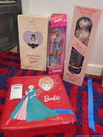 Group shot of carrying case and three boxed dolls