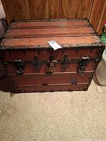 Front view of BAT steamer trunk showing wood slats, metal trim and latches
