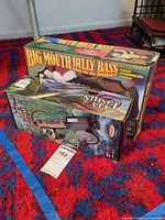 Two boxed items: Big Mouth Billy Bass Holiday and Radica Fly Fishin 9903