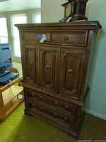 full front view of armoire showing doors and drawers