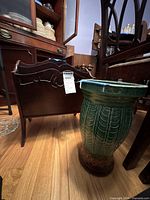 Planter beside wooden magazine rack showing full forms