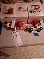 Overall lot showing three ornaments with their boxes