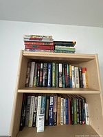 Full view of shelving unit with three levels and stacked books