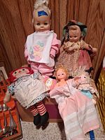 Group shot of all five dolls showing overall condition and variety