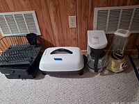 Group view showing skillet, coffee maker, blender and dish rack together