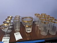 Full grouping of glassware showing all item types and gold/blue rim