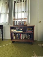 Front view of brown two-shelf bookcase with books displayed