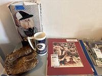 Group shot: boxed referee puppet, NY Giants stein, leather glove, framed baseball print