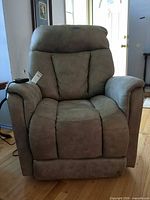 Front view of MotoLift power recliner lift chair showcasing upholstery and overall condition