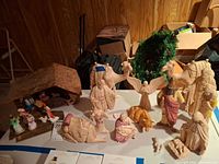 Full nativity set with stable and figurines displayed on table