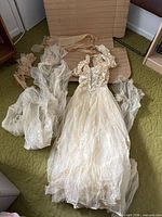 Dress laid out showing bodice, full skirt, detached tulle pieces