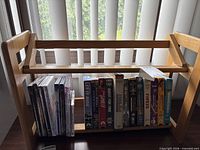 Front view of rack with DVDs and VHS tapes inserted