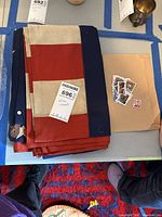 Folded U.S. flag with envelope of stamps beside it