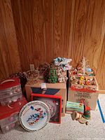 Overall lot showing storage bins, plate, ornament boxes and foliage