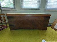 Front view of Virginia Maid hope chest showing lock and medium brown finish