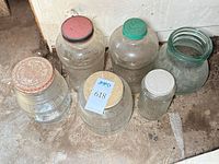 Top view of six large glass jars on floor