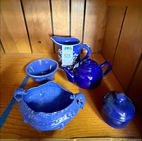 Group shot of five cobalt blue ceramics on shelf