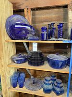 Full shelving showing most of the cobalt blue glass items