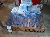 Box with mix of loose blue windowpane glasses and boxed sets