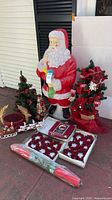 Group shot showing Santa blow mold, trees, sleigh, napkin rings, tablecloth, basket