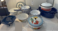 Overall view of assorted enamelware pieces on tabletop
