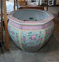 Large hand-painted porcelain planter showing floral exterior and interior koi design