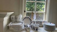 Full set stacked on countertop near window