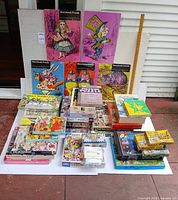 Full lot showing stacked jigsaw puzzle boxes and board game