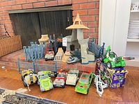 Group shot including playset pieces, vehicles and boxed item