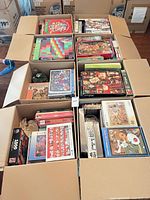 Open U-Haul boxes filled with numerous puzzle boxes