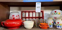 Shelf view showing clown cookie jar, red casserole, ribbed bowl, polka-dot glasses, wooden spice rack with jars, tulip shakers and bowl
