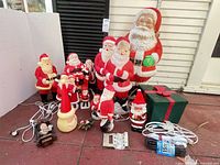 Group shot showing all Santa figures, gift box, cords and accessories