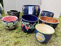 Group shot showing all seven planters, sizes and decoration visible