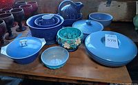Overview of blue casseroles, bowls, pitcher, small bowl and turquoise planter