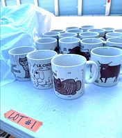 Group of about 21 Taylor & Ng animal mugs on table