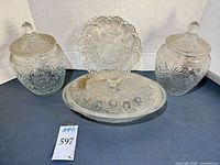 Front view of both cookie jars, oval casserole with lid and deviled egg plate