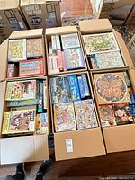 Open carton showing multiple boxed puzzles in rows